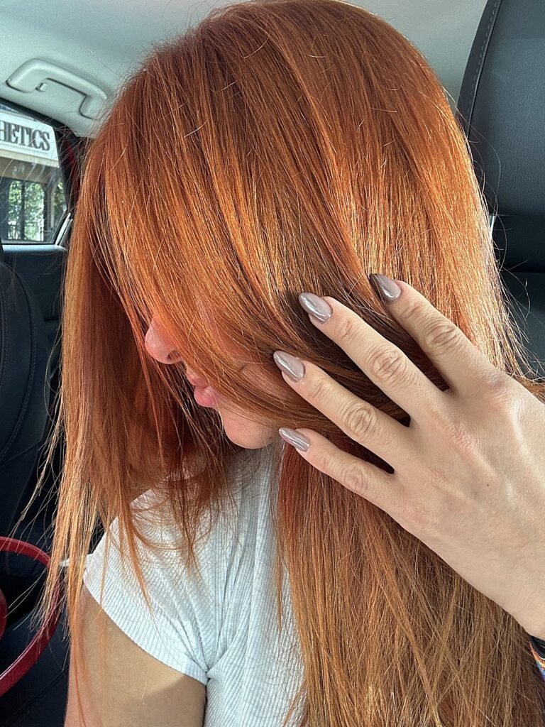 Long, sleek copper red hair