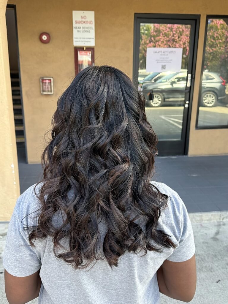 Back view of long, defined dark curls