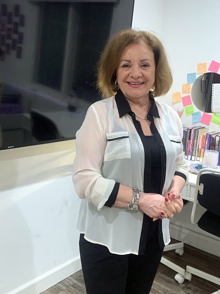 Smiling client standing inside Burbank Hair Studio